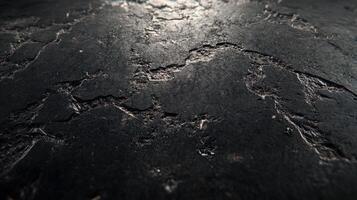 A close up of a black surface with some scratches photo