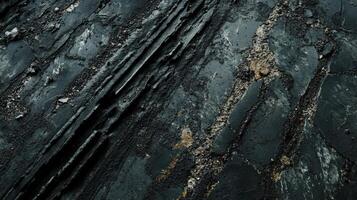 Dark Textured Surface With Deep Grooves And Cracks photo