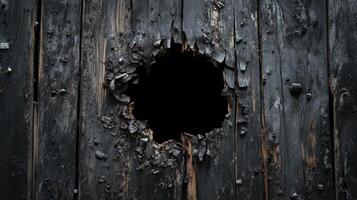Charred Wooden Door With A Circular Hole photo