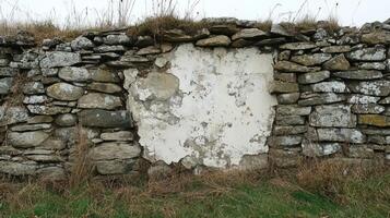 Weathered Stone Wall With Peeling White Plaster photo