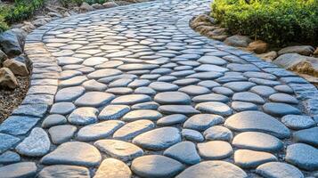Sunlit Cobblestone Path Winding Through Lush Greenery photo