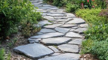 A stone path in a garden with plants and flowers photo