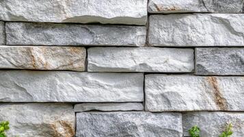 A textured stone wall with grey and beige tones photo