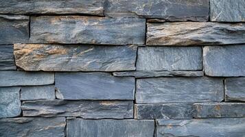 A Textured Wall Of Dark Grey Stone Blocks photo