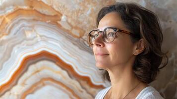 Woman with Glasses Gazes at an Onyx Background photo