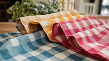 Colorful Gingham Tablecloths Folded on Wooden Table photo
