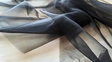 Black Tulle Fabric Draped Softly On A Surface photo