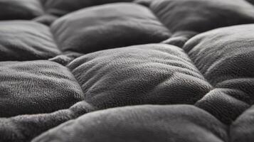 Gray plush quilted fabric texture background photo