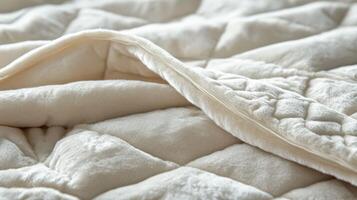 Soft Cream Quilted Blanket Texture Close Up photo
