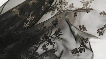 Black Sheer Fabric With Delicate Floral Embellishments photo