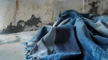 Denim Fabric Draped on a Weathered Surface photo
