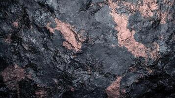Dark Grey Rock Surface With Rose Gold Accents photo