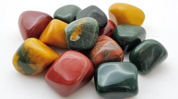 Polished tumbled stones in red yellow and green hues photo