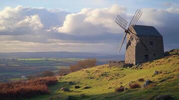 Stone Windmill on Hilltop Overlooking Rolling Countryside photo