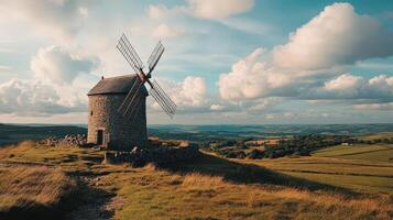 Stone Windmill Stands on Hilltop Overlooking Lush Valley photo