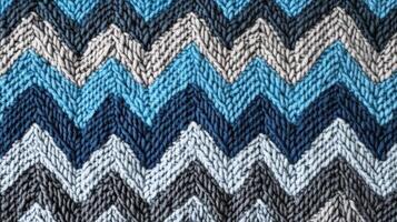 Knitted fabric showing chevron pattern in blues and grays photo