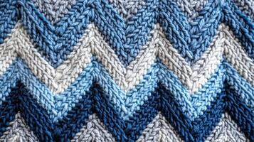 Knitted fabric showing chevron pattern in shades of blue and grey photo