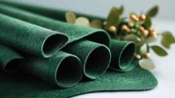 Rolled Dark Green Felt Fabric With Greenery photo