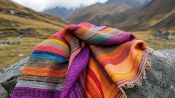Colorful Woven Textile Resting on a Mountain Rock photo