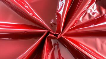 Red glossy fabric swirling in elegant folds photo