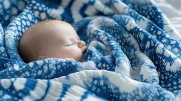 Baby Sleeping Peacefully Underneath Blue Textile photo