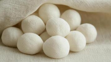 White fabric balls nestled in soft linen cloth photo