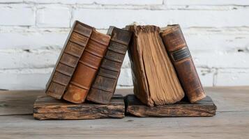 Antique Leather Bound Books Resting On Wooden Stands photo