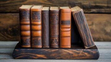 Antique Leather Bound Books Resting On Wooden Shelf photo