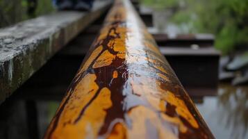 Rusty orange metal pipe bridge detail photo
