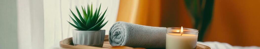 Microfiber towel on wooden tray with plant and candle for relaxation photo
