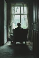 Feeling disconnected in a dimly lit room while facing the window photo