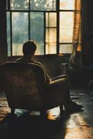 Individual reflecting in dimly lit room during evening hours photo