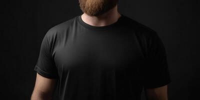 Man with beard wearing a black t-shirt against dark background photo