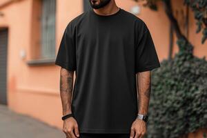 Stylish man posing on street in casual black t-shirt photo