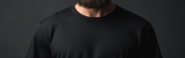 Man wearing black shirt with beard in dark setting photo