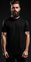 Stylish man in black t-shirt poses against dark background photo