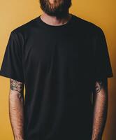 Model poses in black t-shirt against yellow background photo