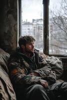 Man reflects on life while sitting in a dilapidated room photo