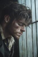 Lonely man gazes out of a dusty window in a dimly lit room photo