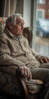Lonely man contemplating life while sitting by the rainy window photo