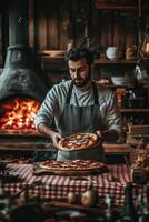 A man in an apron holding a pizza photo
