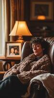 Woman relaxing in a cozy chair with warm lighting at home photo