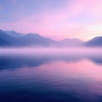 A lake with mountains in the background at sunrise photo