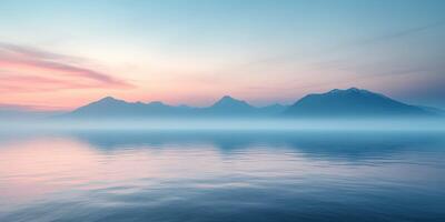 A beautiful sunrise over the mountains with water and fog photo