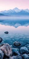 Misty morning landscape with mountains and tranquil lake reflections photo