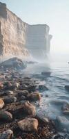 A rocky shoreline with fog and rocks photo
