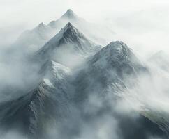 Misty mountain peaks emerge through dense fog in serene nature photo