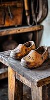 Clogs made from wood placed on a rustic wooden table photo