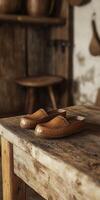 Wooden table showcases handcrafted clogs in rustic setting photo