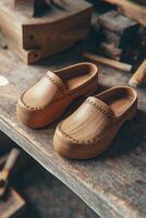Craftsmanship shines in handmade wooden clogs displayed on a shelf photo